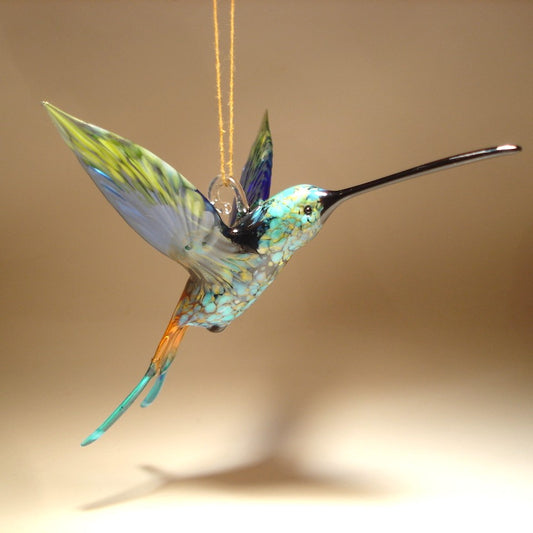 Front view of the swallowtail hummingbird ornament showing the long black beak and a glass hanging hook.