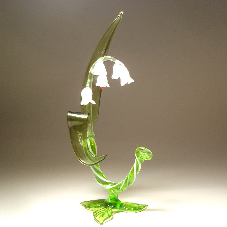 A side view of the glass Lily of the Valley flower figurine, capturing its graceful curves and the arrangement of flowers along the stem.