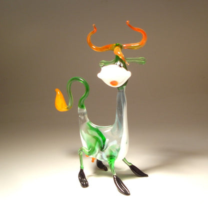 A close-up of the Glass Happy Cow Figurine, showcasing its cheerful expression, with colorful spots and a  smile on its face.