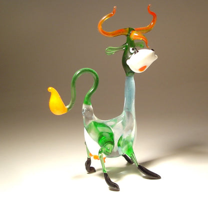 Side view of the Glass Happy Cow Figurine standing on its legs, highlighting its playful pose and curved tail.