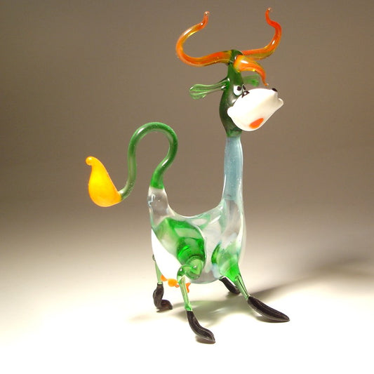 Side view of the Glass Happy Cow Figurine standing on its legs, highlighting its playful pose and curved tail.