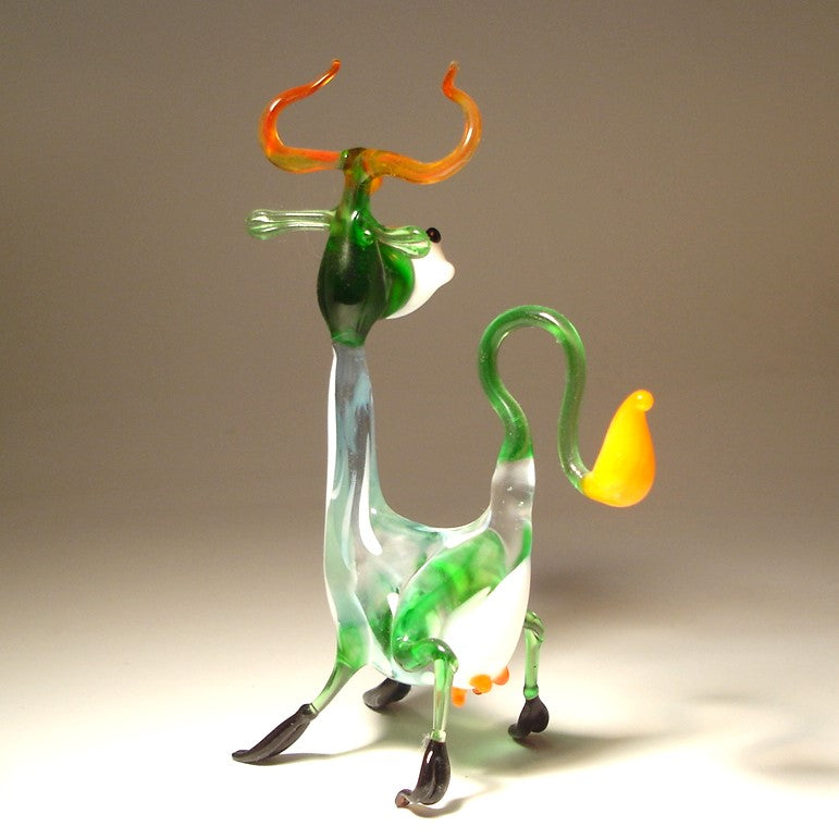 Rear view of the Glass Happy Cow Figurine, emphasizing the curled tail and the long neck.