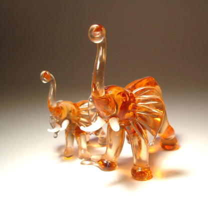 Front view of the glass elephants with a mother on the right.