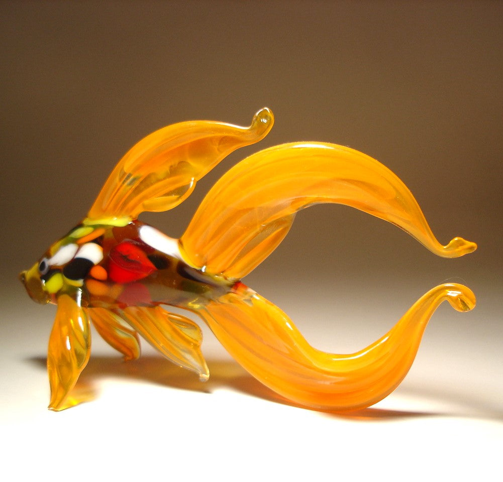 Another view of the orange Betta fish glass figurine, showing the elegant curvature of the fish’s body and the wide double tail.