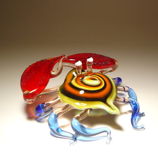 Front view of a glass crab figurine with vibrant red claws, showcasing its detailed colorful shell and legs.