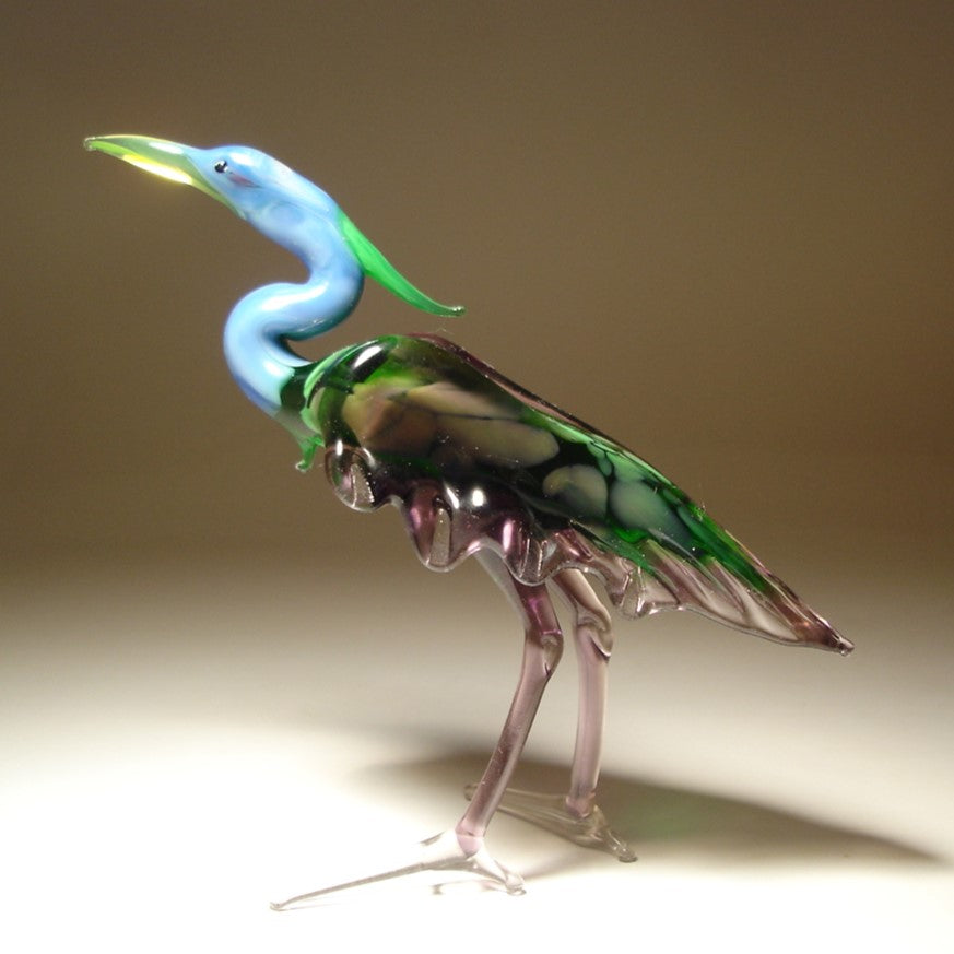 Handmade glass blue neck heron figurine with  intricate details of its feathers and poised posture.