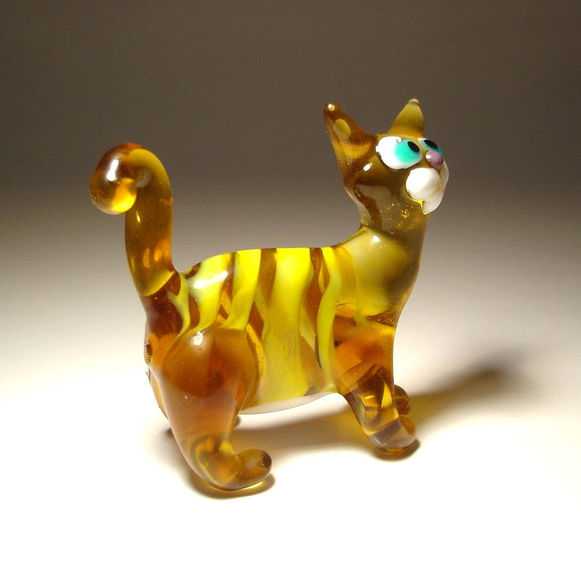 a side view of the brown glass cat highlighting the yellow stripes