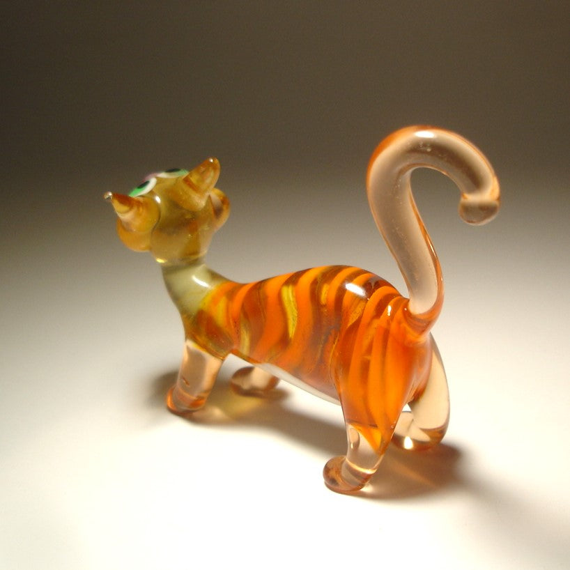 A back view of the glass cat  showing its short clear glass legs and upright clear ears. 