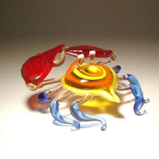 Handmade glass crab sculpture wit a swirled shell and blue legs