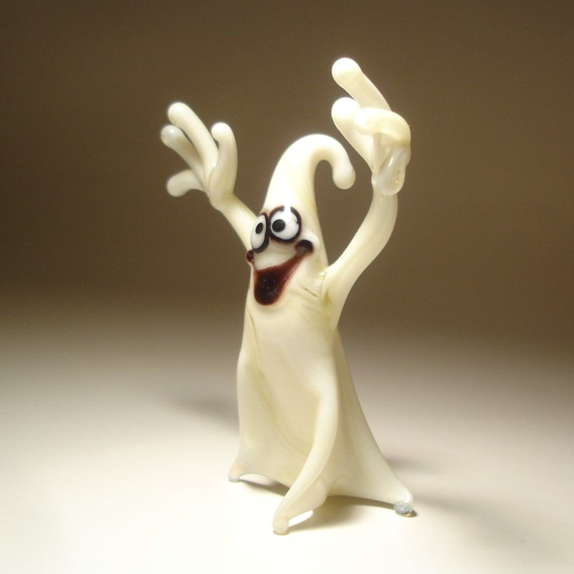 Close-up of the glass white ghost figurine with a smile on its face, showcasing playful expression.