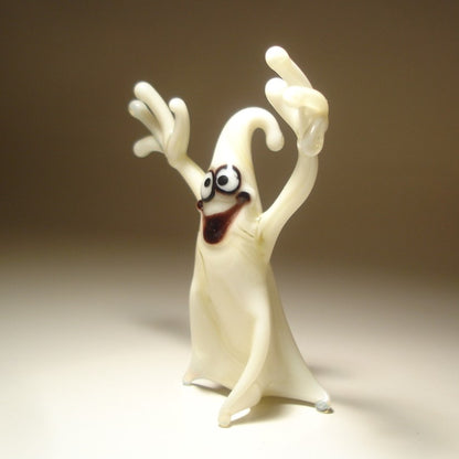 Close-up of the glass white ghost figurine with a smile on its face, showcasing playful expression.