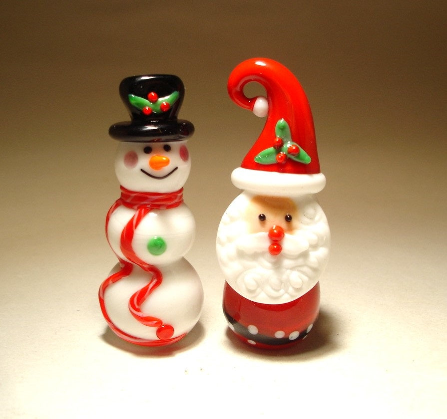 Combined view of both the glass Santa Claus and snowman figurines, highlighting their festive designs and cheerful demeanor.