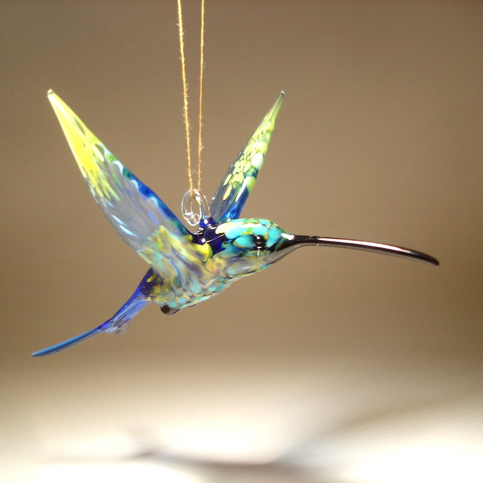 Front view of the swallowtail hummingbird ornament showing the long black beak and a glass hanging hook.
