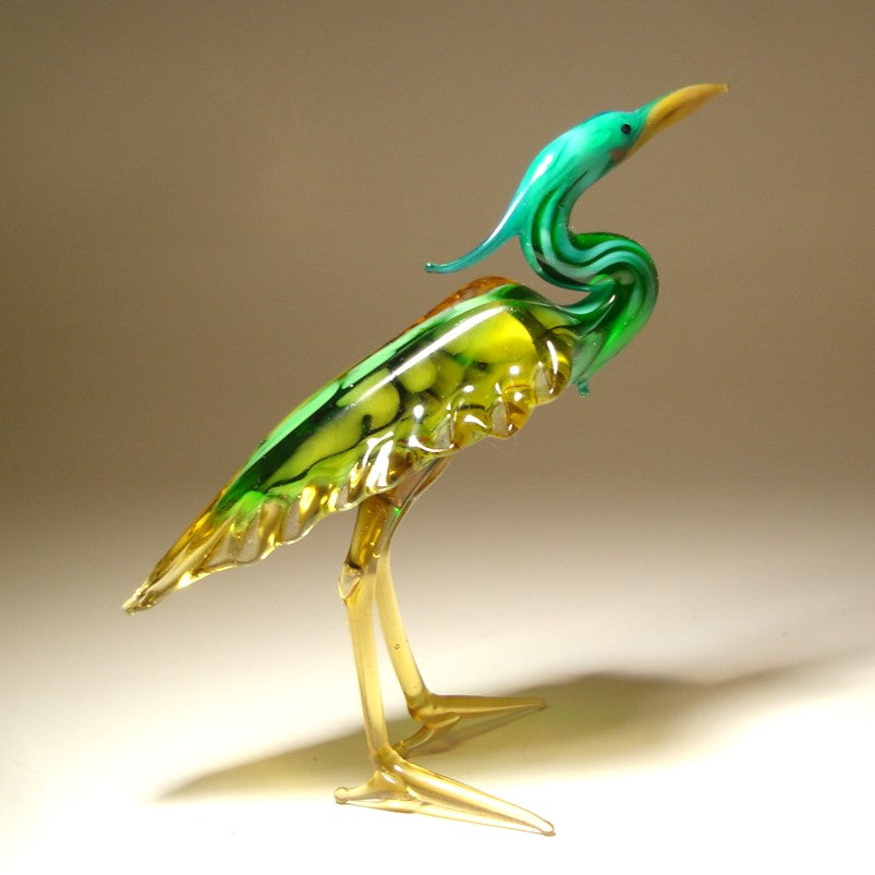Handmade glass blue neck heron figurine with  intricate details of its feathers and poised posture.