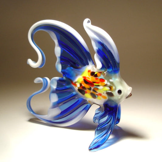 Opposite side view of a handmade blue glass and white fish figurine, showcasing its vibrant blue fins and tail 