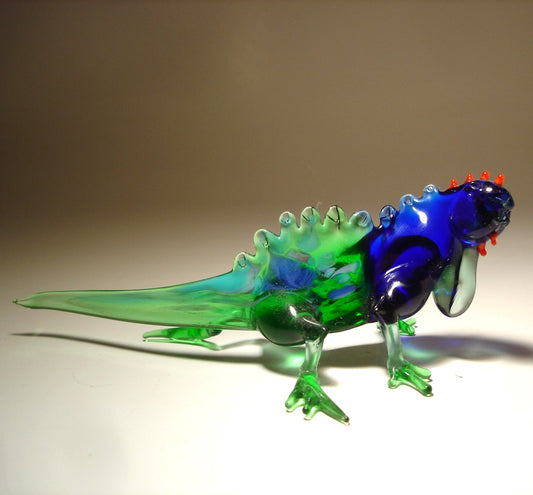 Side view of the glass Grand Cayman iguana figurine, highlighting its ridged body, detailed legs, and long tail.