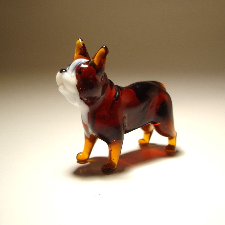 Close-up of the glass Boston Terrier figurine's face, highlighting its charming expression and glossy brown and white markings.