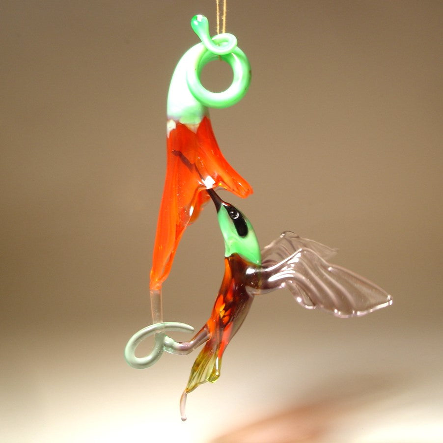 The other side of the hanging hummingbird and a red trumpet flower