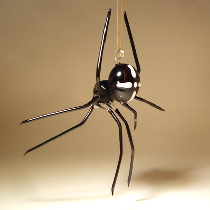 A black spider-shaped hanging ornament with glossy white eye details and a clear glass loop at the top.