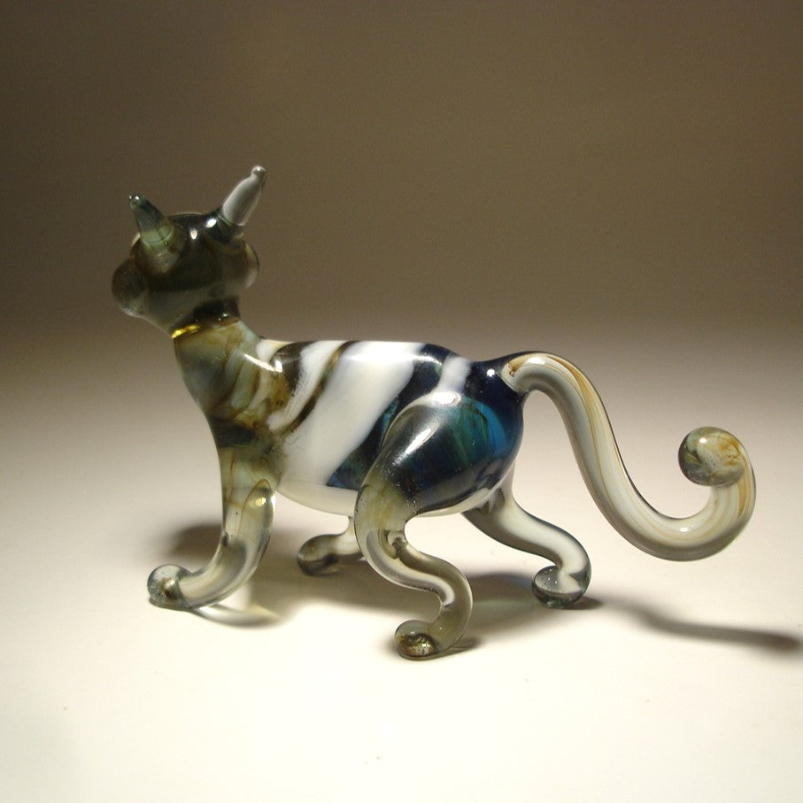 A glass figurine of a walking cat glass figurine.