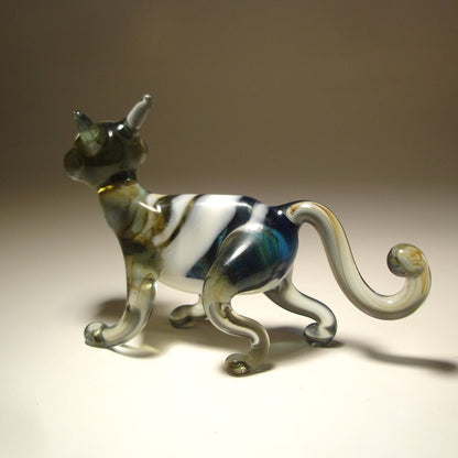 A glass figurine of a walking cat glass figurine.