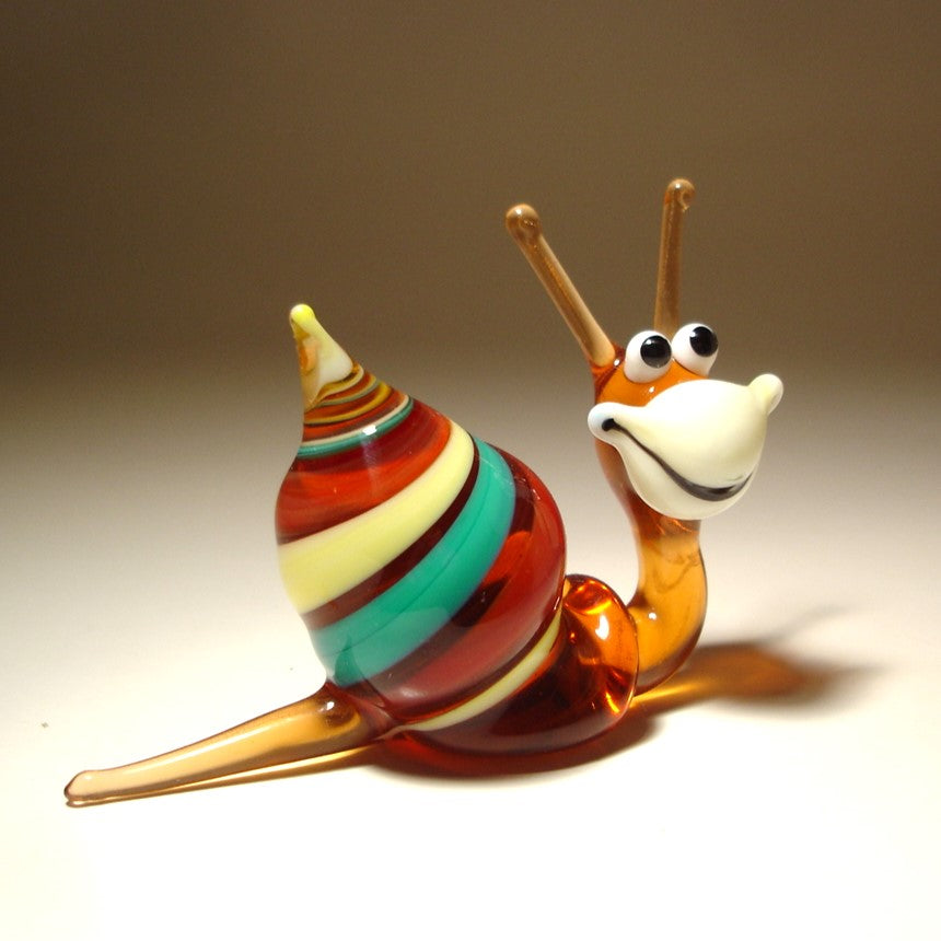 ide view of the Glass Happy Snail Figurine, displaying its colorful spiral shell as it appears to crawl, with its cheerful expression.