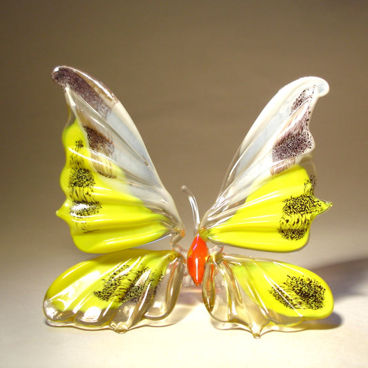 Handmade glass yellow and white figurine with tiny black specs on its wings