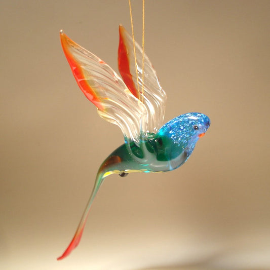 A colorful glass Hanging Blue & Red Parrot Parakeet ornament, gracefully suspended, showcasing its vibrant blue and red feathers.