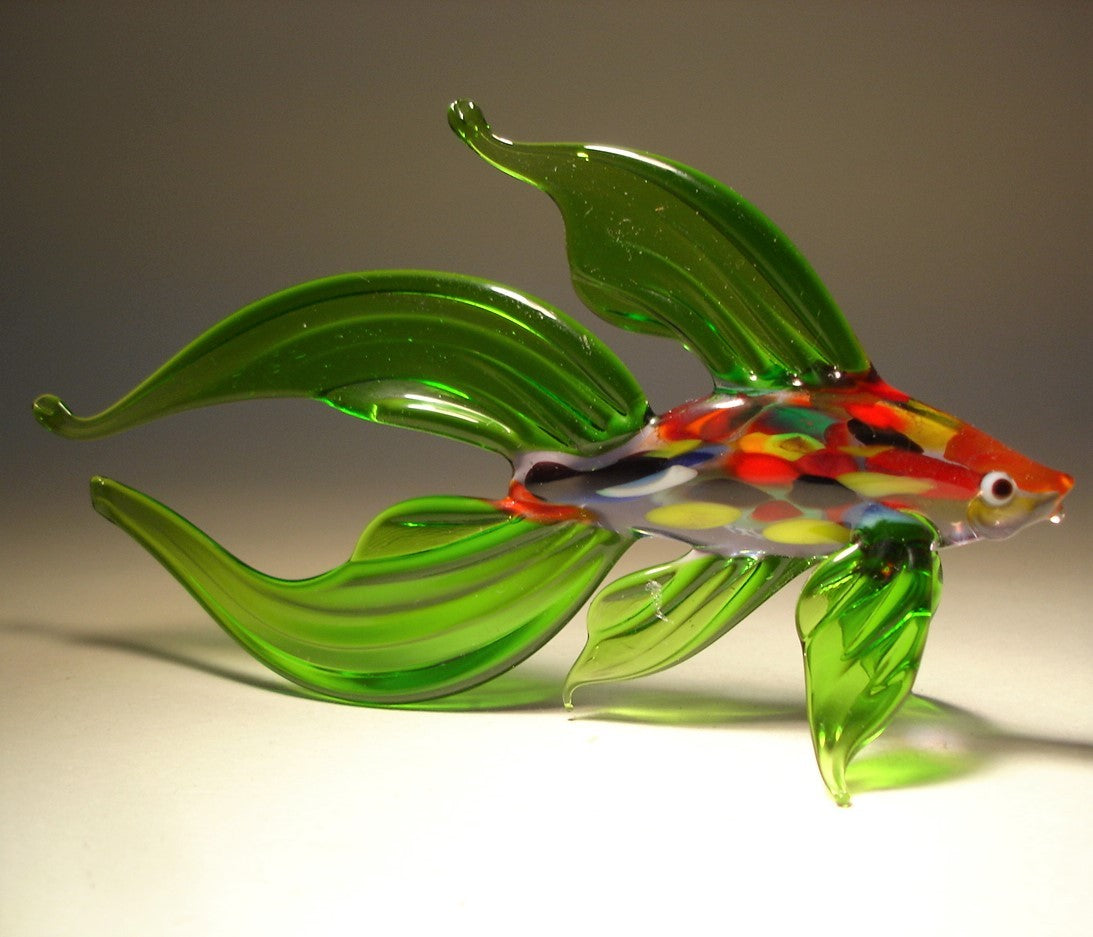 A green glass Betta fish figurine, showcasing its wide, flowing fins and slightly flared tail.