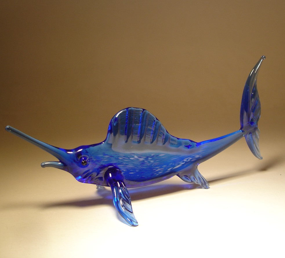 A side profile of the marlin glass figurine, highlighting the elongated, sleek body and the pronounced dorsal fin. 