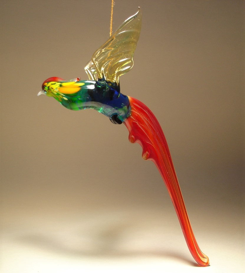 A glass Hanging Bird Pheasant figurine ornament, suspended from a thread, featuring red, blue and green plumage. 