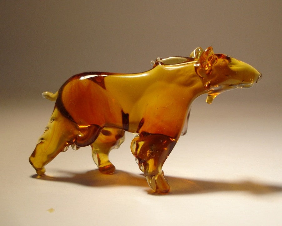 Side view of the glass brown bear figurine, focusing on the intricate craftsmanship of the bear's face, paws, and textured fur