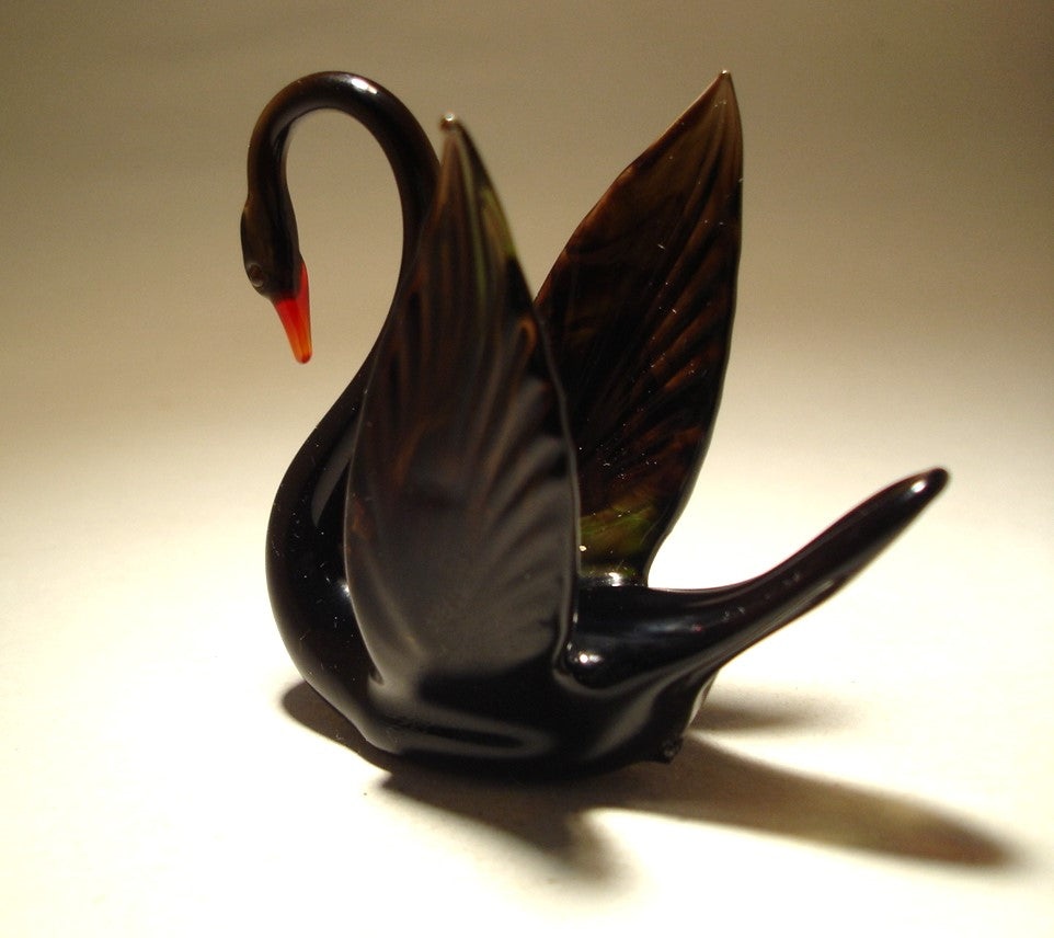 Handcrafted black glass swan figurine, displaying the shape of its wings 