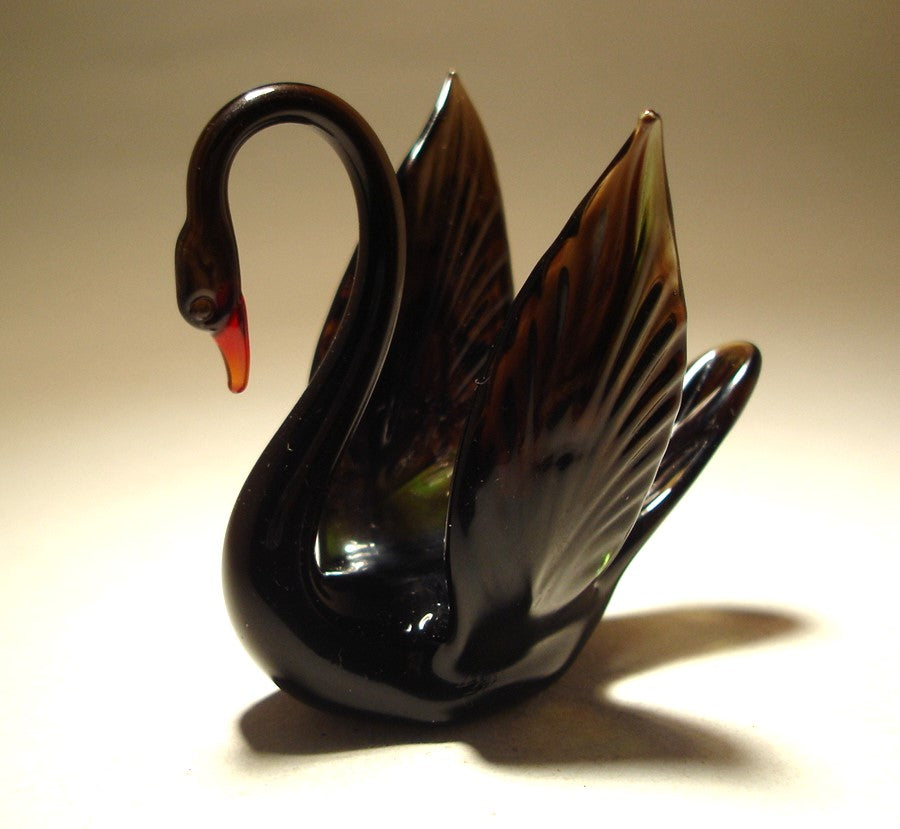 Left side view of the handcrafted black glass swan figurine, highlighting its elegant curved neck and sleek body