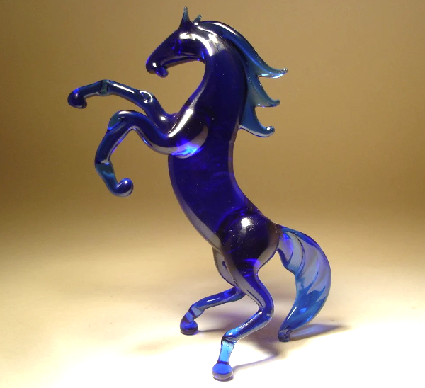 blue glass horse figurine standing on hind legs an supported by it's tail