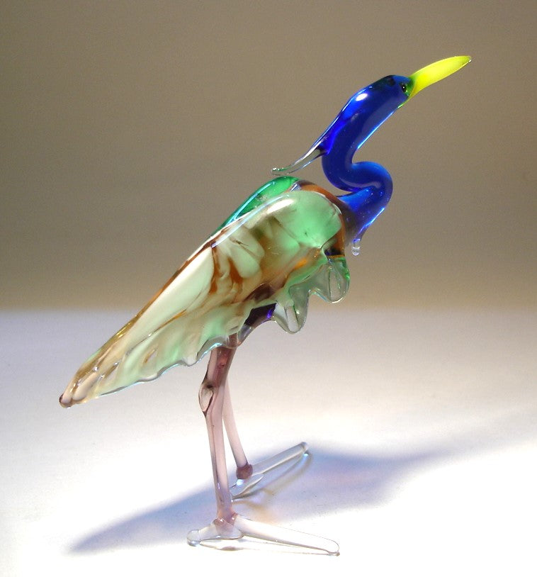 Back view of the glass heron figurine, highlighting the detailed green and brown wings and slender legs.