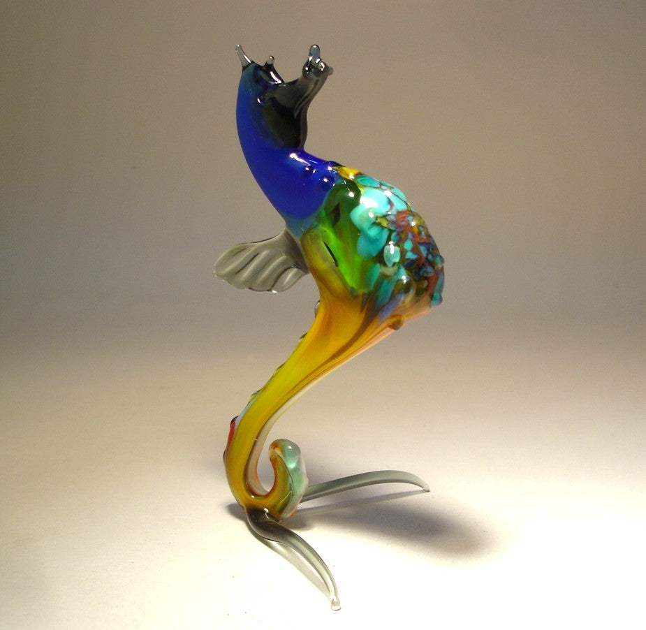 Front view of a glass blue seahorse figurine, showcasing its curled tail and detailed aqua blue textured body.