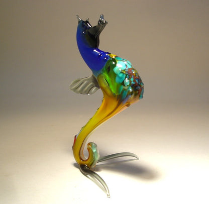 Front view of a glass blue seahorse figurine, showcasing its curled tail and detailed aqua blue textured body.