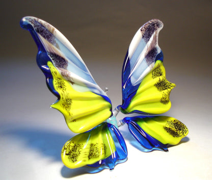 The blue, yellow and white glass butterfly turned to the right