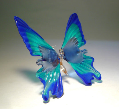 handcrafted blue glass butterfly ornament, highlighting the delicate patterns on its wings - right side view