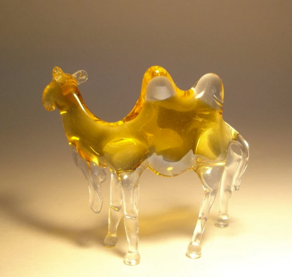 Side view of the glass camel figurine, highlighting its elegant neck and detailed fur.