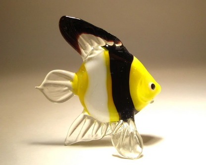 Glass clownfish figurine standing on its clear fins