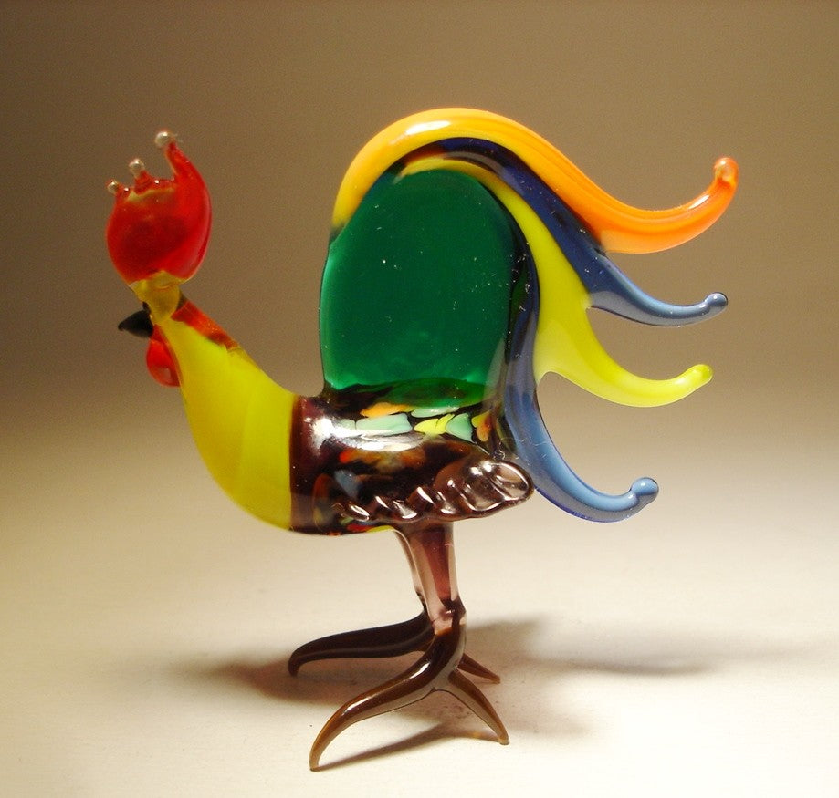 A back view of a glass rooster figurine featuring a stunning array of colorful tail feathers and yellow neck.