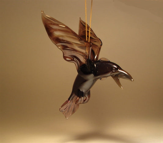 A handcrafted glass raven crow figurine ornament in dark purple with its beak open.