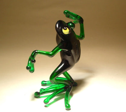 Front view of a glass dancing frog figurine, showing the frog mid-dance with one leg slightly raised and arms extended.