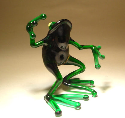 Side view of the glass dancing frog figurine, highlighting the frog's playful posture and vibrant green color.