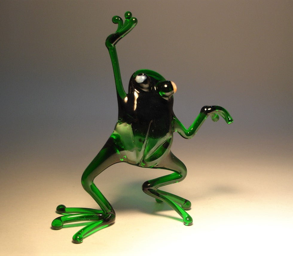 Close-up of the glass dancing frog figurine, capturing the cheerful expression and animated dance movement.