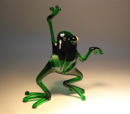 Close-up of the glass dancing frog figurine, capturing the cheerful expression and animated dance movement.