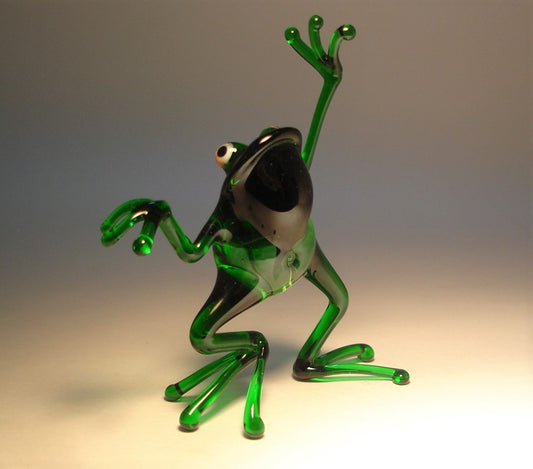 Front view of the glass dancing frog figurine, emphasizing the lively posture and rich green color.