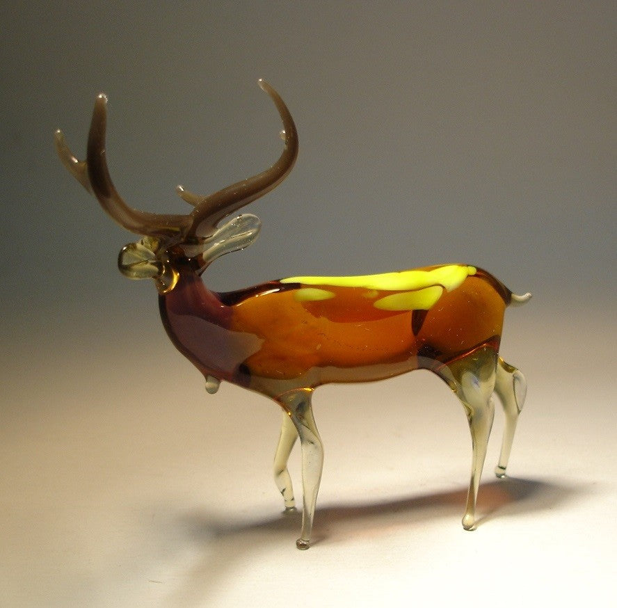 A side view of the glass deer figurine, showcasing its graceful, elongated neck and clear glass legs.